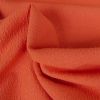 Tissu polyester texturé corail - orange x 10 cm
