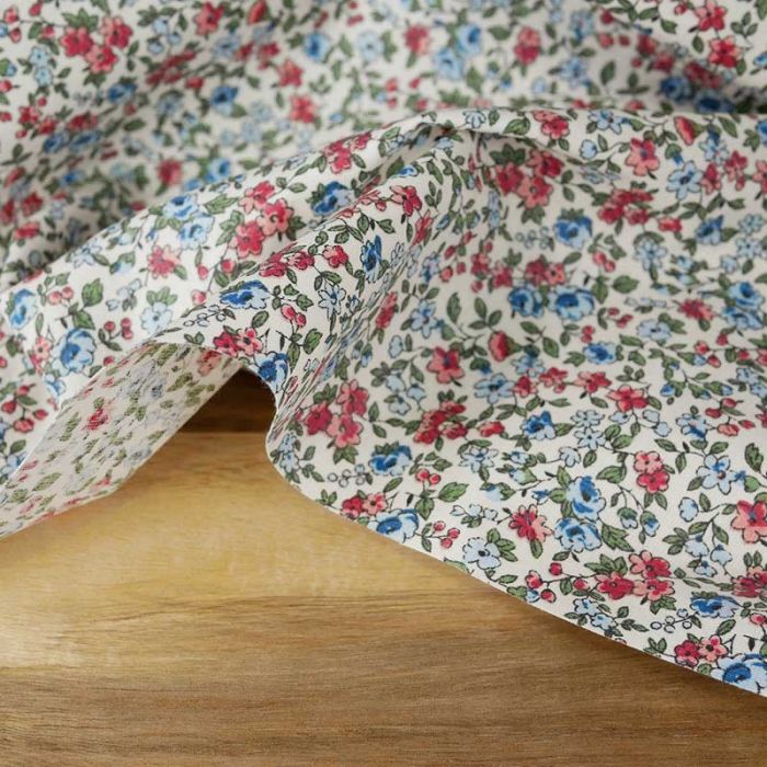 Tissu coton enduit fleurs - rose bleu ciel x 10 cm