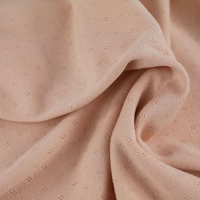 Tissu jersey ajouré pointelle - rose nude x 10 cm
