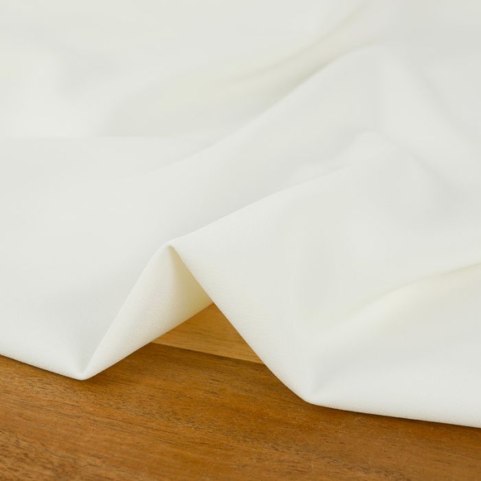 Tissu crêpe stretch polyester uni - blanc cassé x 10 cm