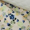 Tissu matelassé fleurs pochoirs - écru x 10 cm