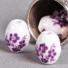 Perle en céramique Fleurie ovale violette x1