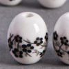 Perle en céramique Fleurie ovale noire 14mm x1