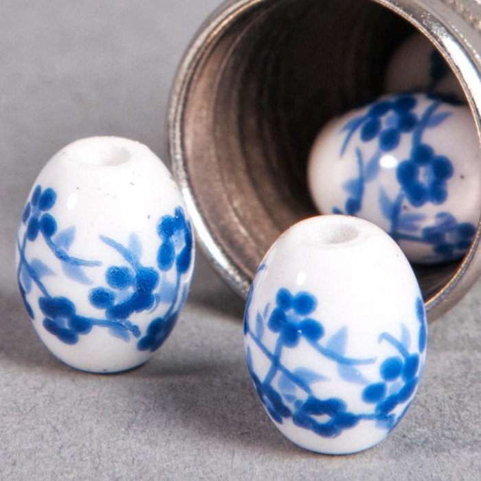 Perle en céramique Fleurie ovale bleu roi 10mm x1
