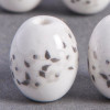 Perle en céramique Fleurie ovale blanche 14mm x1