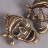 Breloque tête de mort pirate 27mm bronze x1