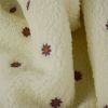 Tissu fausse fourrure Teddy fleurs brodées - écru x 10 cm