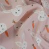 Tissu imperméable souple lapins - rose clair x 10 cm