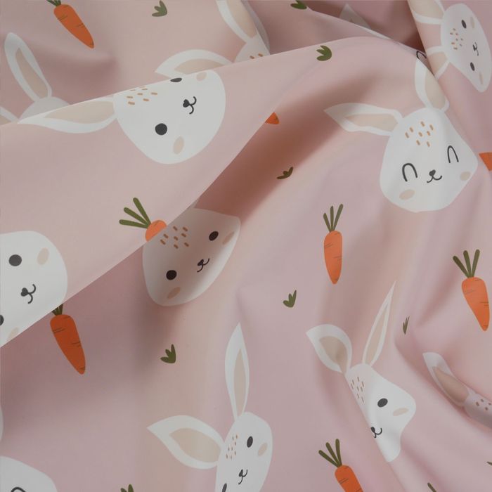 Tissu imperméable souple lapins - rose clair x 10 cm