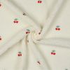 Tissu fausse fourrure sherpa broderie cerises - écru x 10 cm