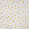 Tissu coton plumetis citrons - écru x 10 cm