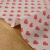 Tissu coton enduit coeurs rouges - rose clair x 10 cm
