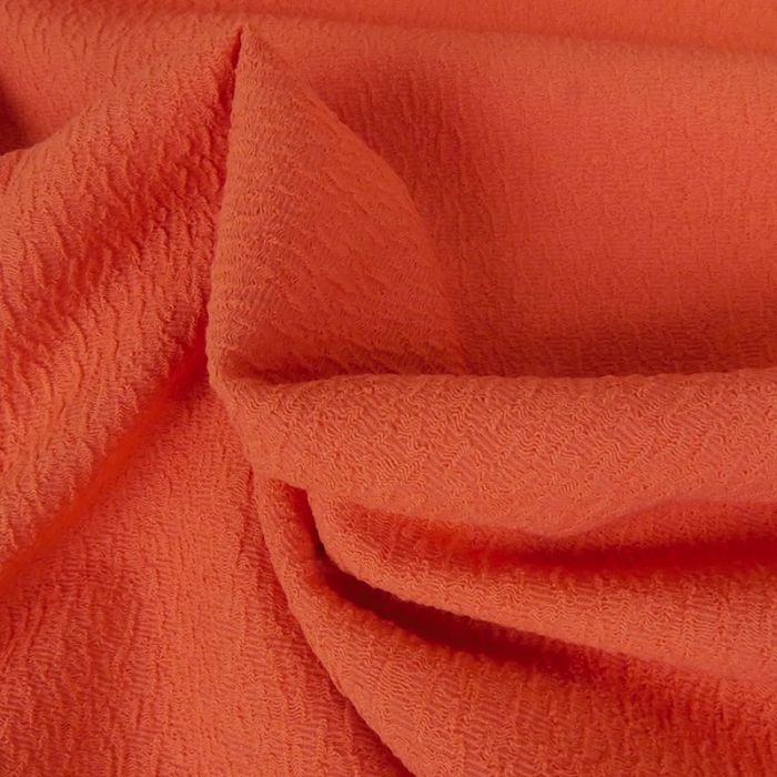 Tissu polyester texturé corail - orange x 10 cm